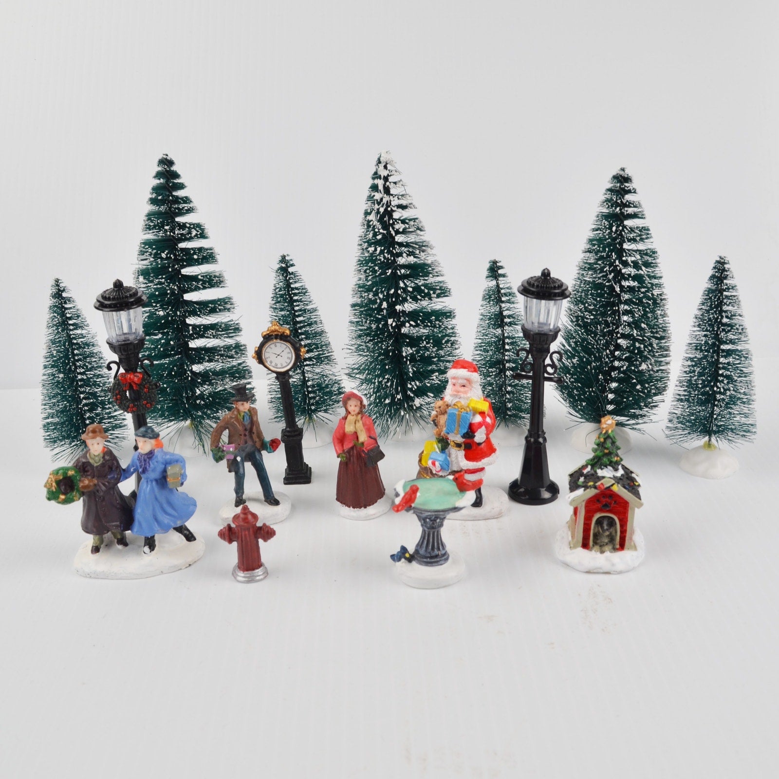Lot of 17 Holiday Time Christmas Village Trees Figures Lamp People Santa Clock